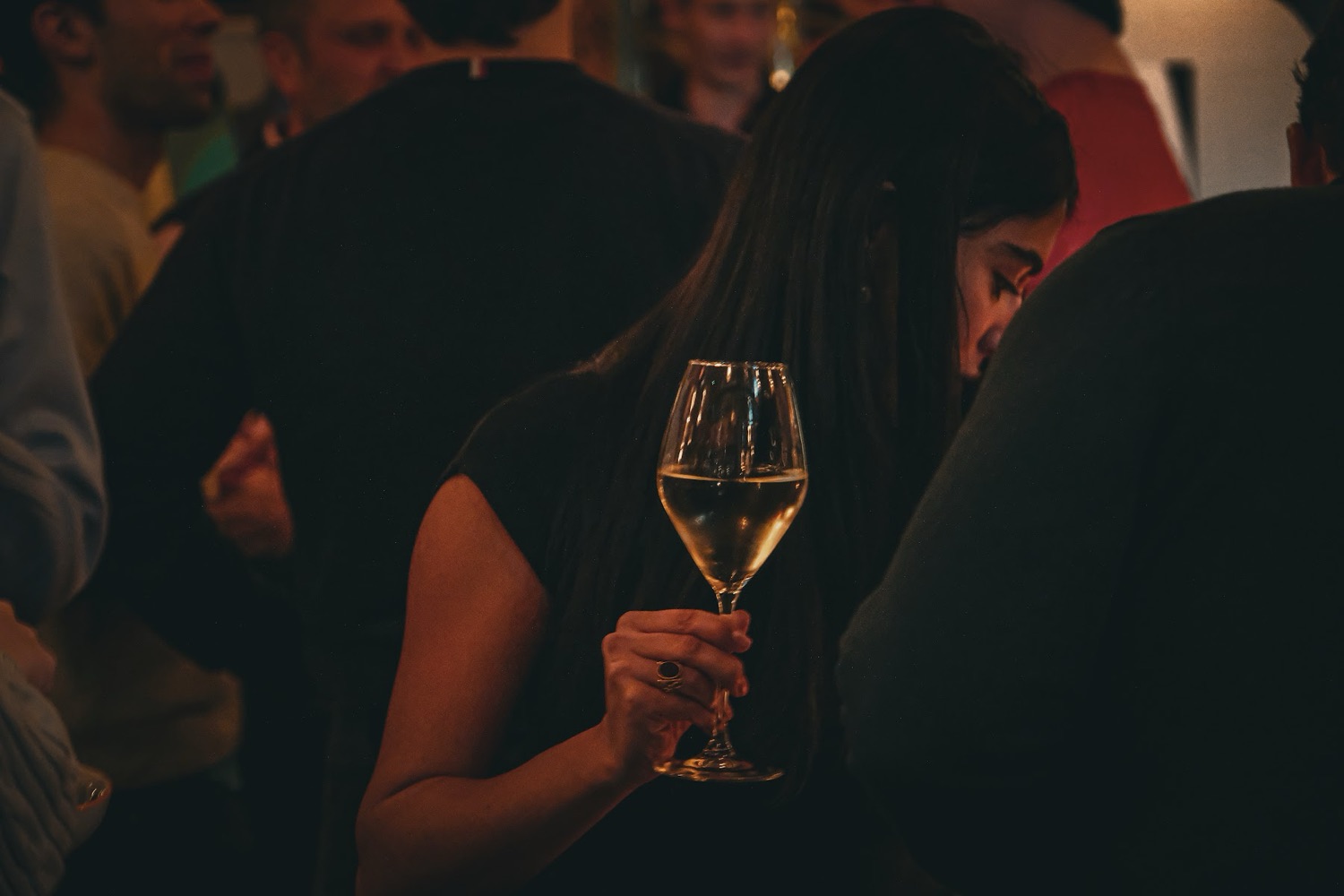 A guest with a glass of wine